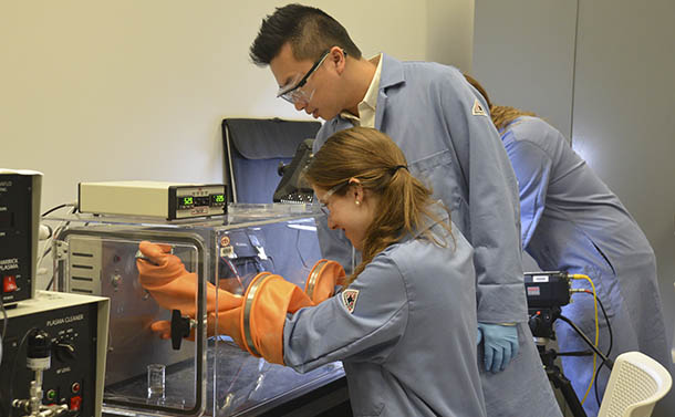 Wong helping student in lab